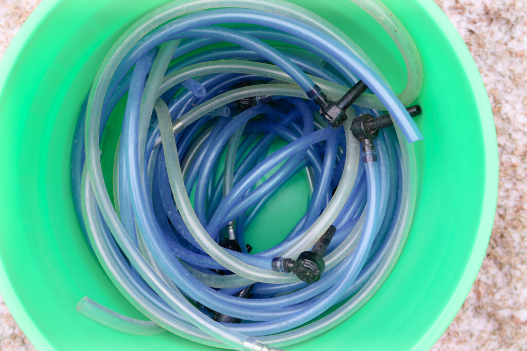 Bucket full of Tapping hoses and taps